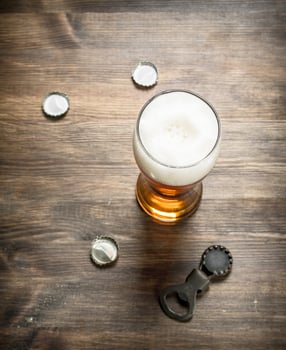 glass of beer with stoppers and a bottle opener. photo