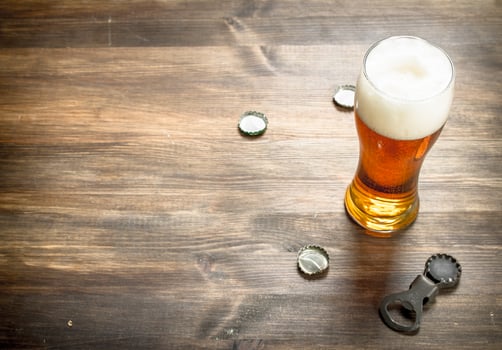 glass of beer with stoppers and a bottle opener. photo