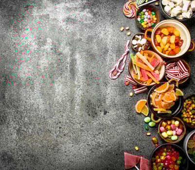 Multicolored candy, jelly and marshmallows in a bowl. photo