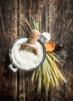 Flour in a bowl with chicken egg. photo