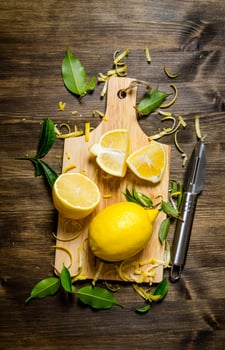 Cut the lemon zest on the Board. On wooden table. photo