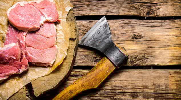 Fresh raw minced meat with an axe. photo