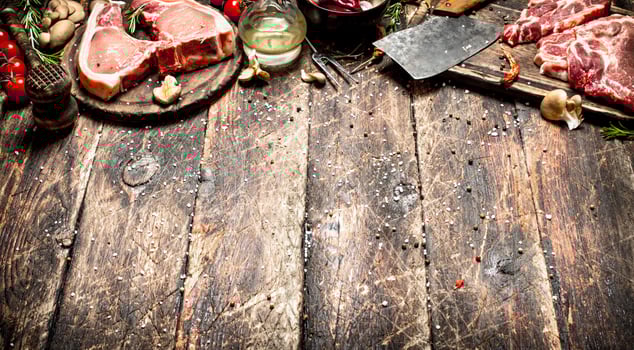 Raw meat background. Raw pork chop with a variety of herbs and spices. photo