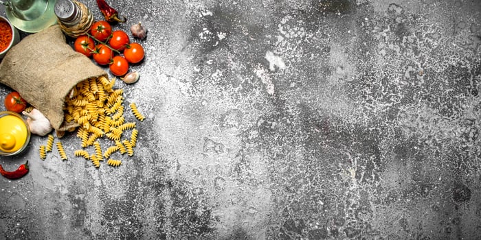 Pasta background. Pasta with sauces, vegetables and olive oil. photo