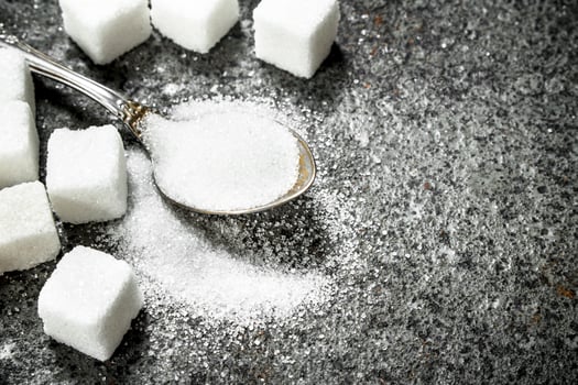 Sugar in a teaspoon. photo