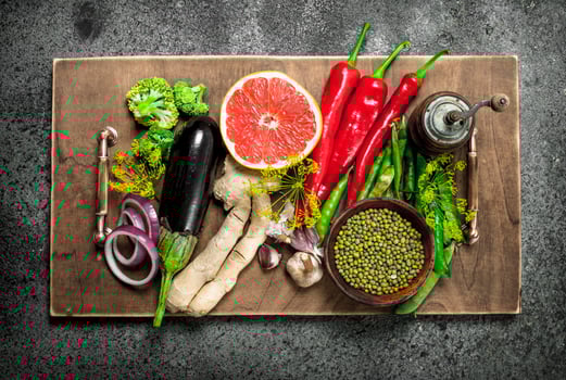 Organic food. Legumes and fresh vegetables on a wooden tray. photo