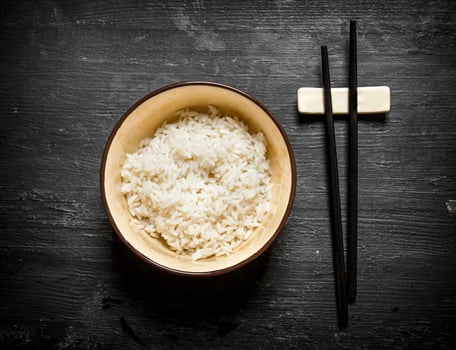 Boiled rice with chopsticks. photo