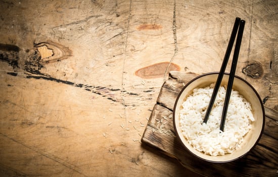 Boiled rice with chopsticks. photo