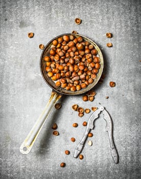 Hazelnuts and a Nutcracker in the old pan. photo