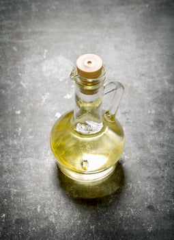Olive oil in a jug. On stone background. photo