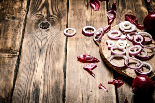 Onion rings with seeds on a wooden Board. photo