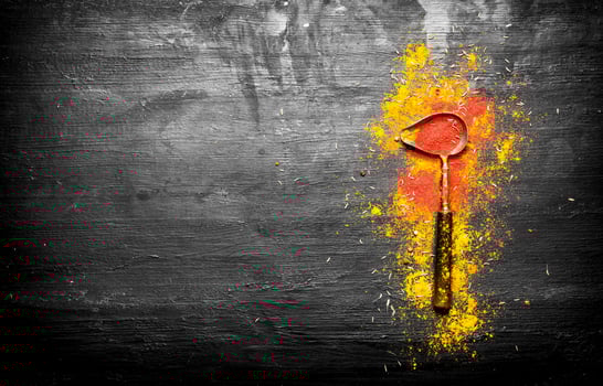 Grinded Indian spices in an old spoon photo