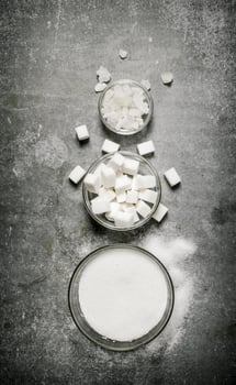 Different types of white sugar in a glass . photo