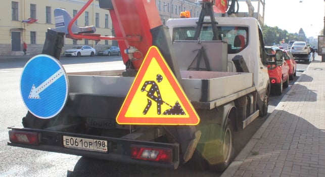Sankt Petersburg Russia - 10 16 2023 Truck sign roadworks. There are warning signs on the back of the truck. Road works in progress photo