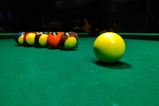Pool cues close-up on a green table for playing photo