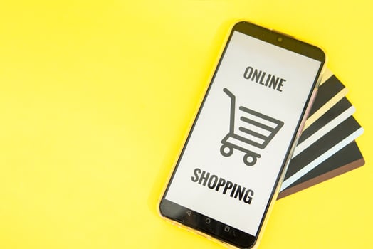 Smartphone with the inscription-online shopping close-up. Online shopping, online banking, online payment. Payment with plastic cards. Flat Ley on a yellow background. photo