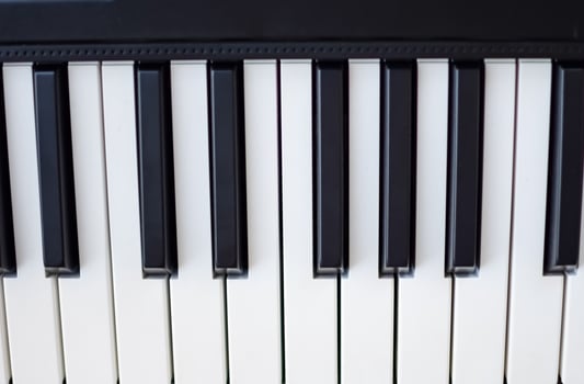 Close-up of piano keys. Piano black and white keys and Piano keyboard musical instrument placed at the home balcony during sunny day. photo
