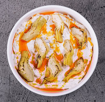 artichokes with truffle sauce in white bowl photo
