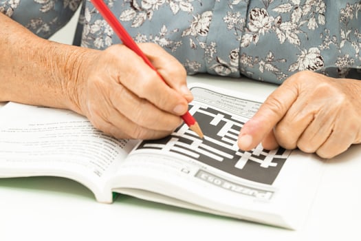 Alzheimer disease AD, Asian elderly woman playing sudoku puzzle game to practice for dementia prevention. photo