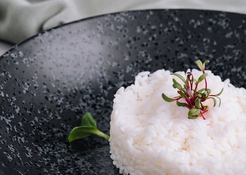 Portion of classic italian risotto on black plate photo