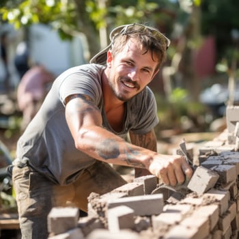 Mason laying bricks to build a wall photo