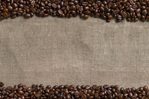 Coffee beans on burlap background. photo