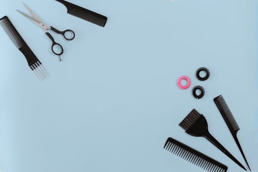 Hairdresser set with various accessories on blue background photo