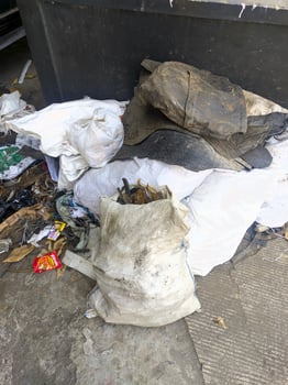 Piles of rubbish waste and rubbish sacks on the side of the road, rubbish piled up on the side of the city road photo
