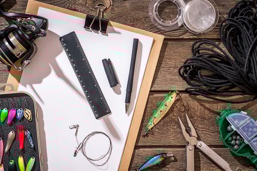 Fishing tackle - fishing spinning, fishing line, hooks and lures on wooden background. photo