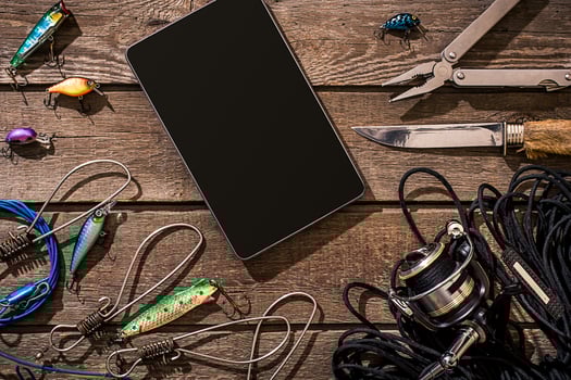 Accessories for fishing on the background of wood. Top view photo
