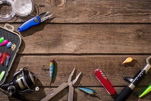 Accessories for fishing on the background of wood. Top view photo