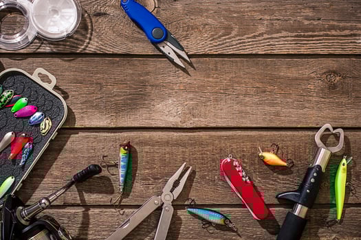 Accessories for fishing on the background of wood. Top view photo
