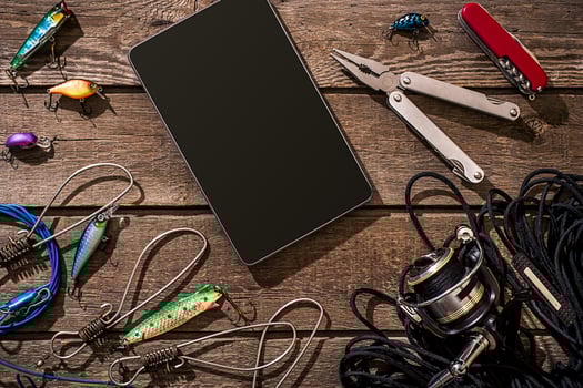 Accessories for fishing on the background of wood. Top view photo