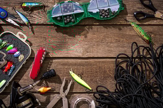 Accessories for fishing on the background of wood. Top view photo