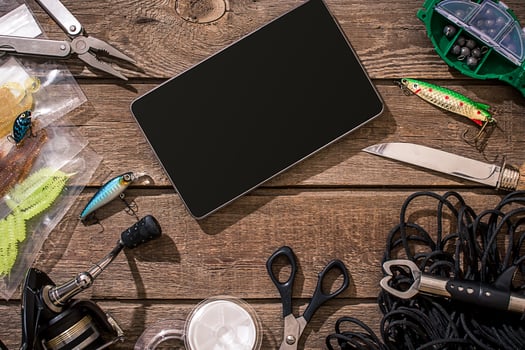 Accessories for fishing on the background of wood. Top view photo