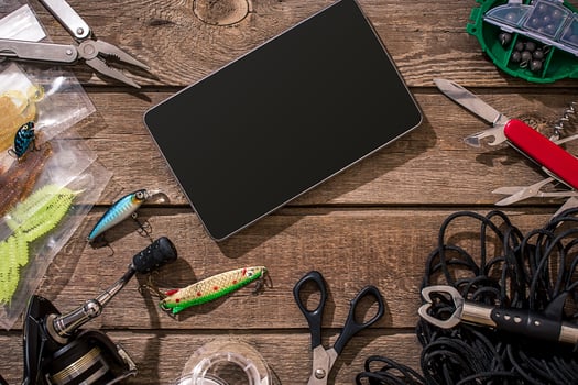 Fishing tackle - fishing spinning, fishing line, hooks and lures on wooden background. photo