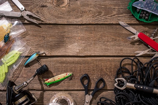 Fishing tackle - fishing spinning, fishing line, hooks and lures on wooden background. photo