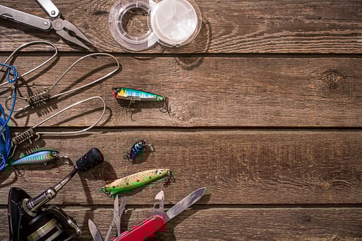 Accessories for fishing on the background of wood. Top view photo