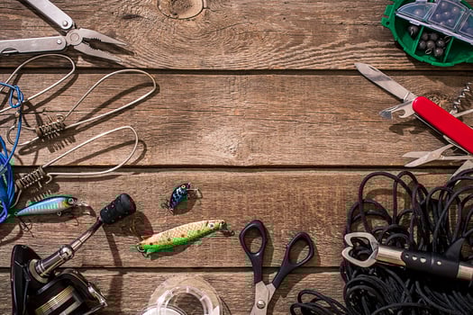 Fishing tackle - fishing spinning, fishing line, hooks and lures on wooden background. photo