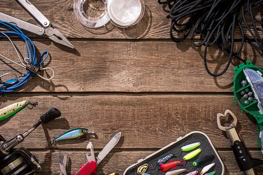 Accessories for fishing on the background of wood. Top view photo