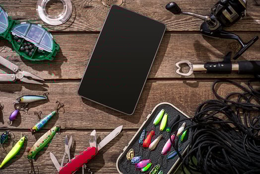 Fishing tackle - fishing spinning, fishing line, hooks and lures on wooden background. photo