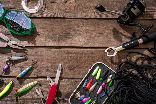 Fishing tackle - fishing spinning, fishing line, hooks and lures on wooden background. photo