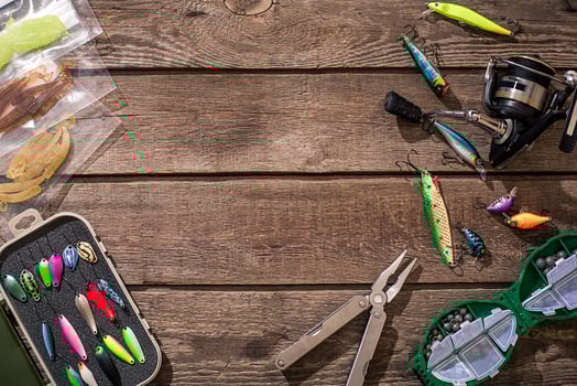 Fishing tackle - fishing spinning, fishing line, hooks and lures on wooden background. photo