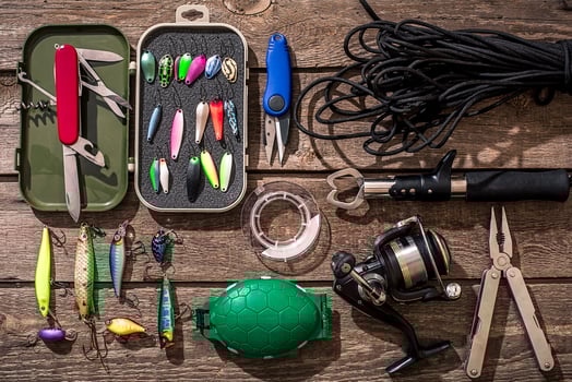 Fishing tackle - fishing spinning, fishing line, hooks and lures on wooden background. photo
