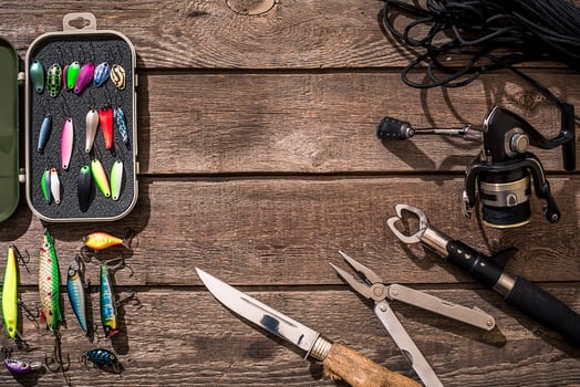 Fishing tackle - fishing spinning, fishing line, hooks and lures on wooden background. photo