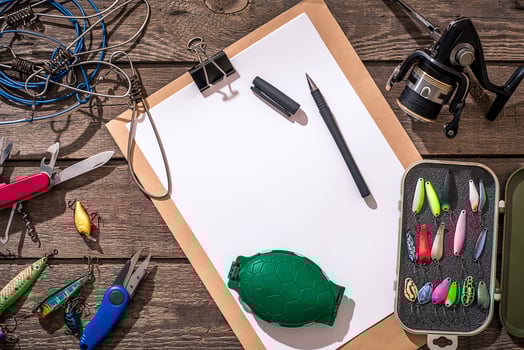 Fishing tackle - fishing spinning, fishing line, hooks and lures on wooden background. photo