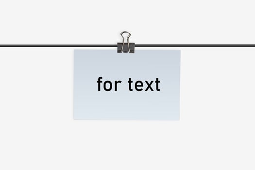 A small piece of paper with inscription for text, clamped by binder clip to a wire and hanging on it. Isolated on white. Close up, copy space photo