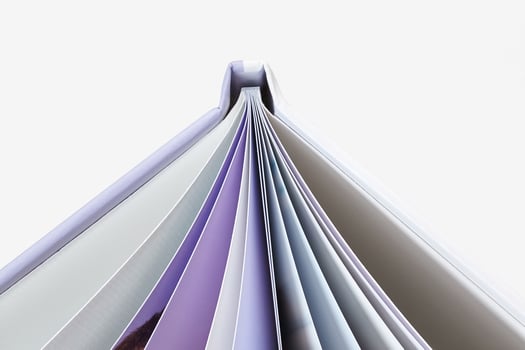 Open, high quality photo book with hardback and pages with colorful images isolated on white studio background. Close up, copy space