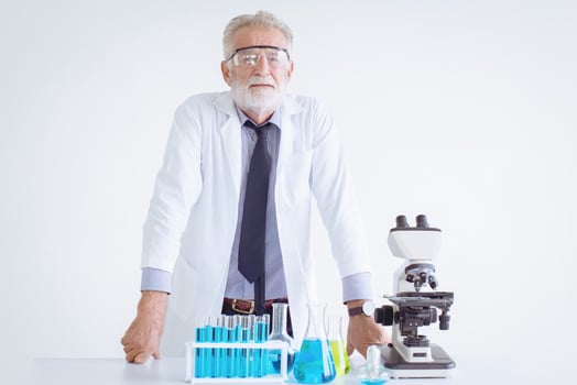 Portrait Doctor senior elderly scientist chemist standing in chemical science lap with microscope photo