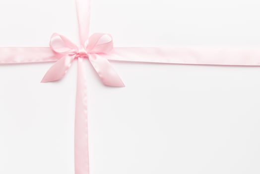 Top view of purple ribbon rolled and pink bow isolated on colored background. Flat lay with copy space photo